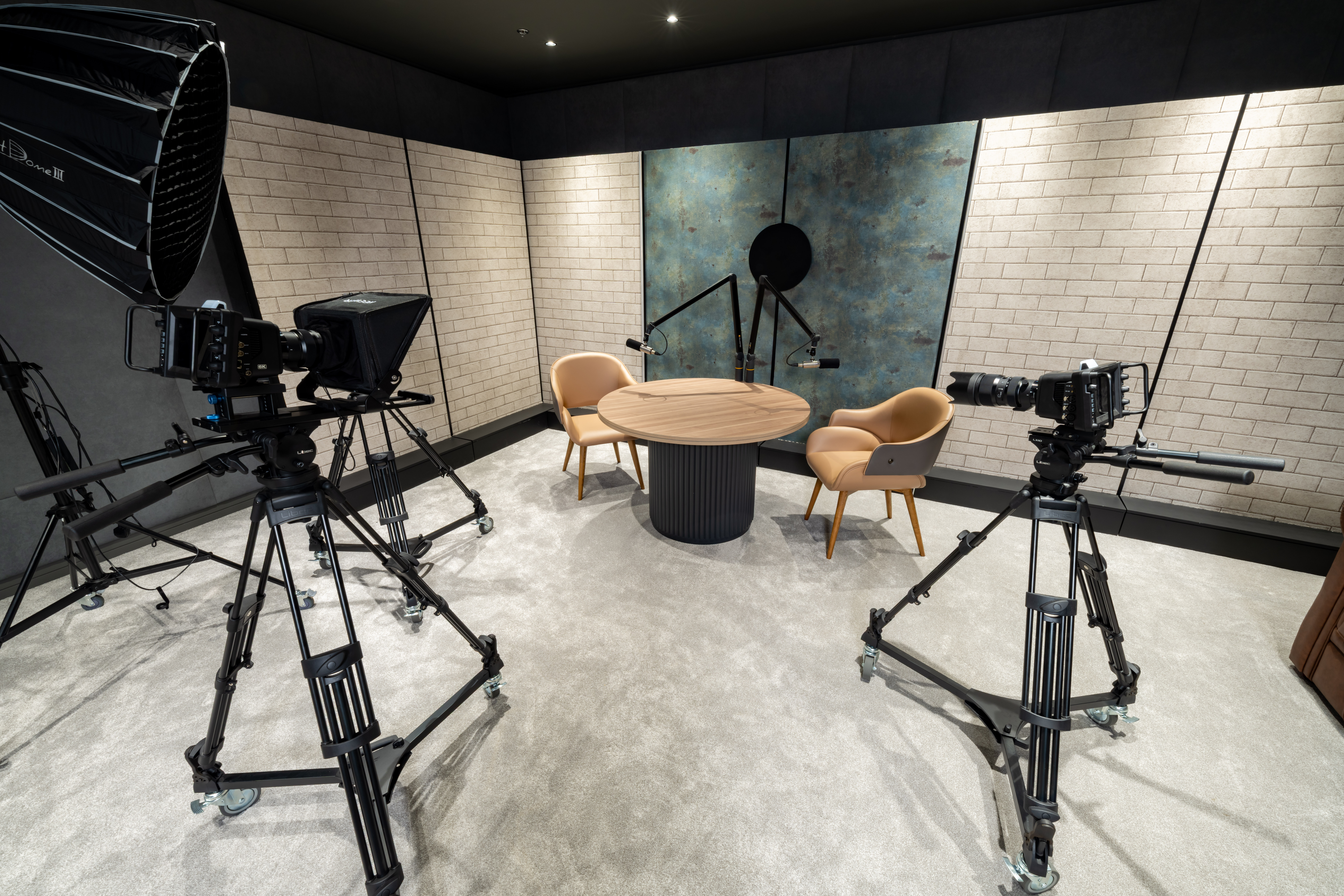Podcast set with brick acoustic panels and round table